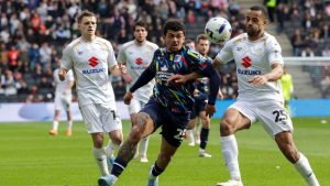 Barrow’s Josh Gordon, left, battles with MK Dons’ Curtis Nelson