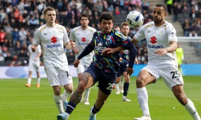 Barrow’s Josh Gordon, left, battles with MK Dons’ Curtis Nelson