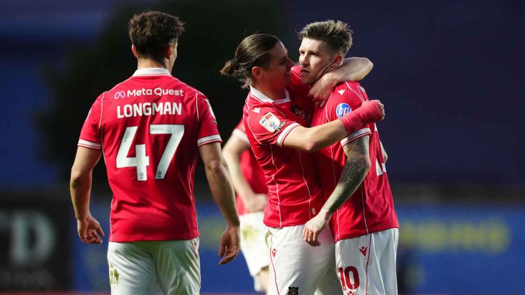 Josh Windass, right, is congratulated after scoring Wrexham&rsquo;s winner at Oxford United 