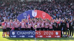 Lincoln City’s players lift the League One trophy