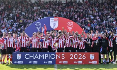 Lincoln City’s players lift the League One trophy