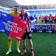 Lincoln City goalkeeper George Wickens and Dom Jefferies celebrate promotion