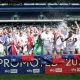 MK Dons players celebrate their promotion to League One