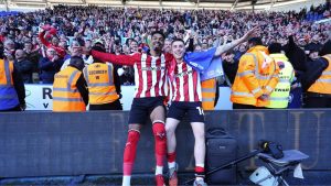 Lincoln City's Reeco Hackett, left, and Dom Jefferies celebrate promotion