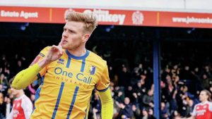 Will Evans celebrates his equaliser for Mansfield Town against Arsenal in the FA Cup