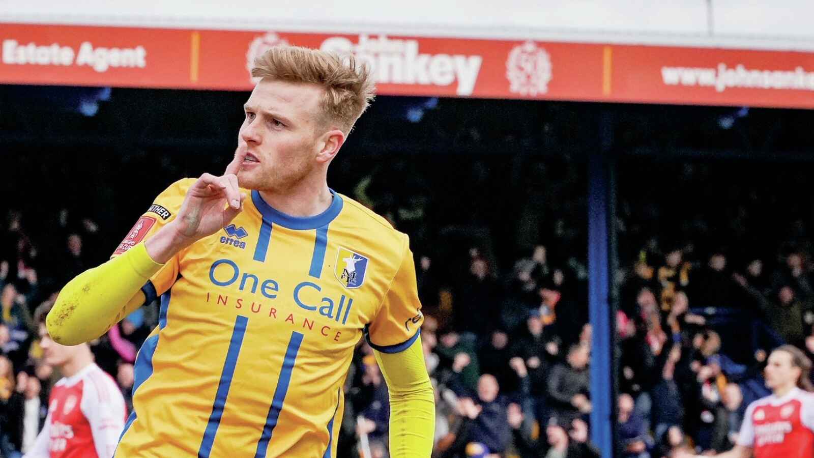 Will Evans celebrates his equaliser for Mansfield Town against Arsenal in the FA Cup