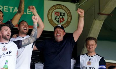 Bromley manager Andy Woodman (centre) celebrates in the stands