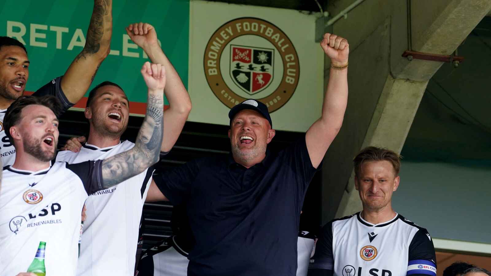 Bromley manager Andy Woodman (centre) celebrates in the stands