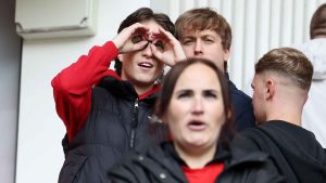 A Middlesbrough fan makes a binoculars gesture during the Championship play-off match against Southampton
