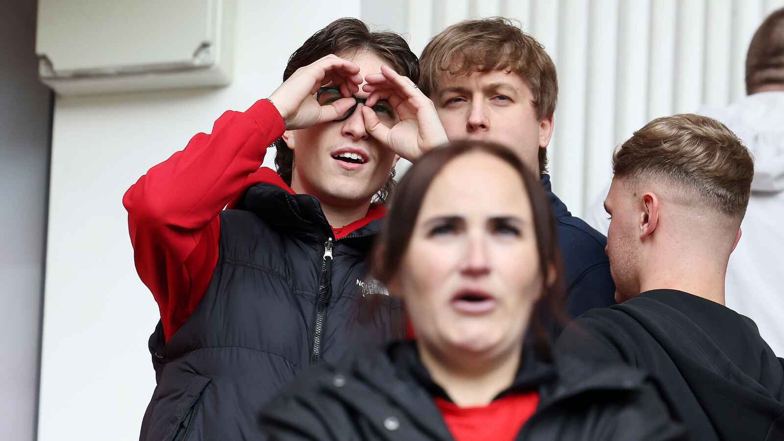 A Middlesbrough fan makes a binoculars gesture during the Championship play-off match against Southampton