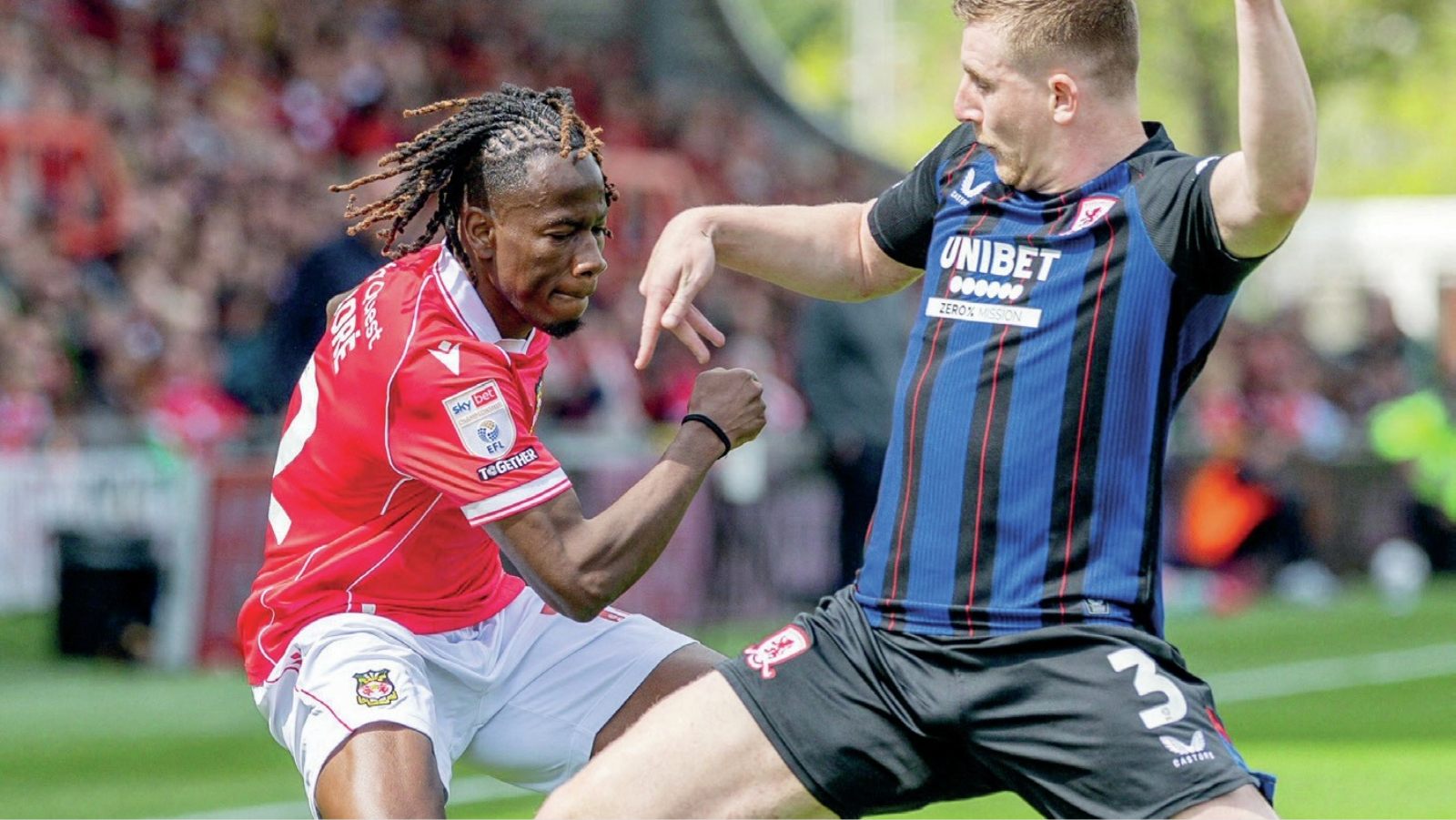 Wrexham’s Issa Kabore, left, is challenged by Middlesbrough’s Matt Targett