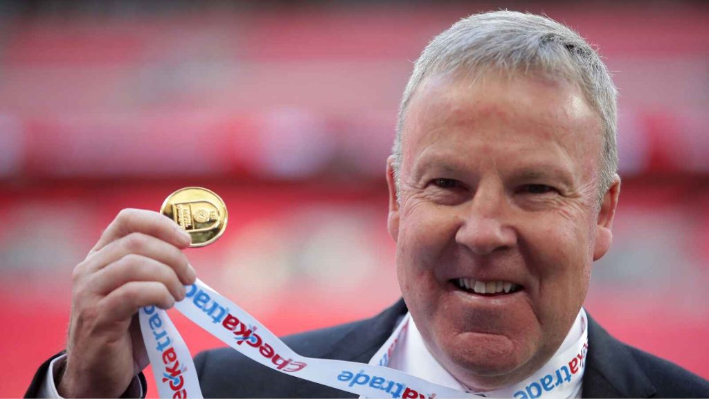 Kenny Jackett holds up his medal after winning the Checkatrade Trophy with Portsmouth