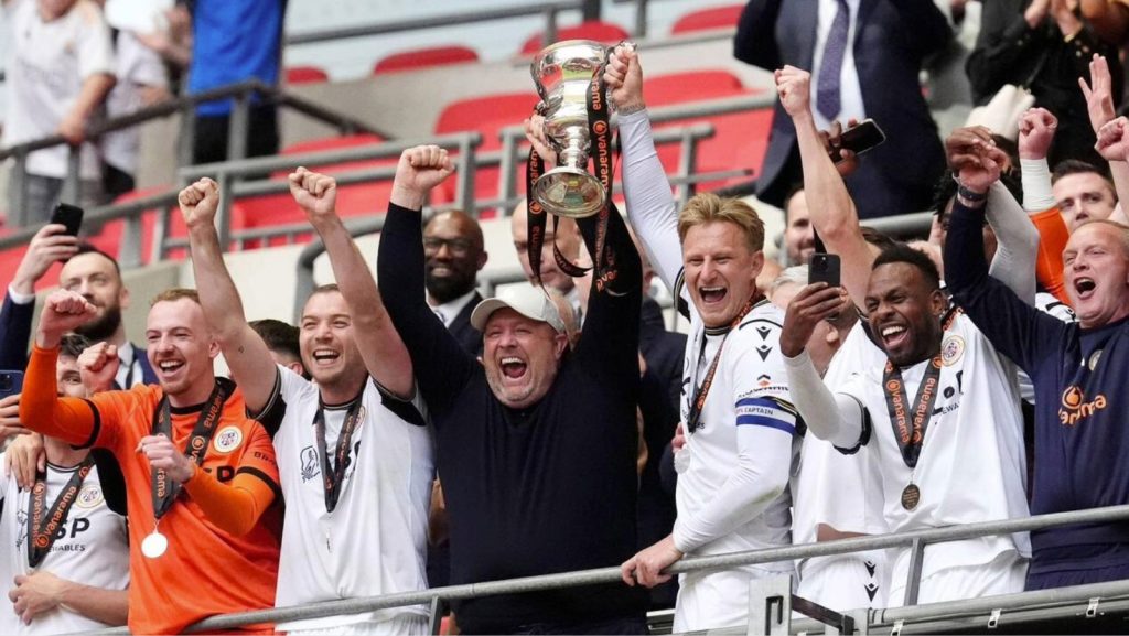 Bromley manager Andy Woodman, centre, celebrates promotion into the EFL in 2024