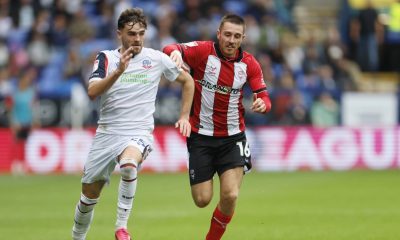 Bolton Wanderers’ Max Conway is chased by Lincoln City’s Dominic Jefferies