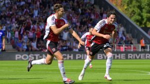 Exeter City skipper Jack Fitzwater, left, enjoys his early goal