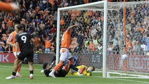 Blackpool’s Jerry Yates pokes past Peterborough United’s Alex Bass to make it 4-0