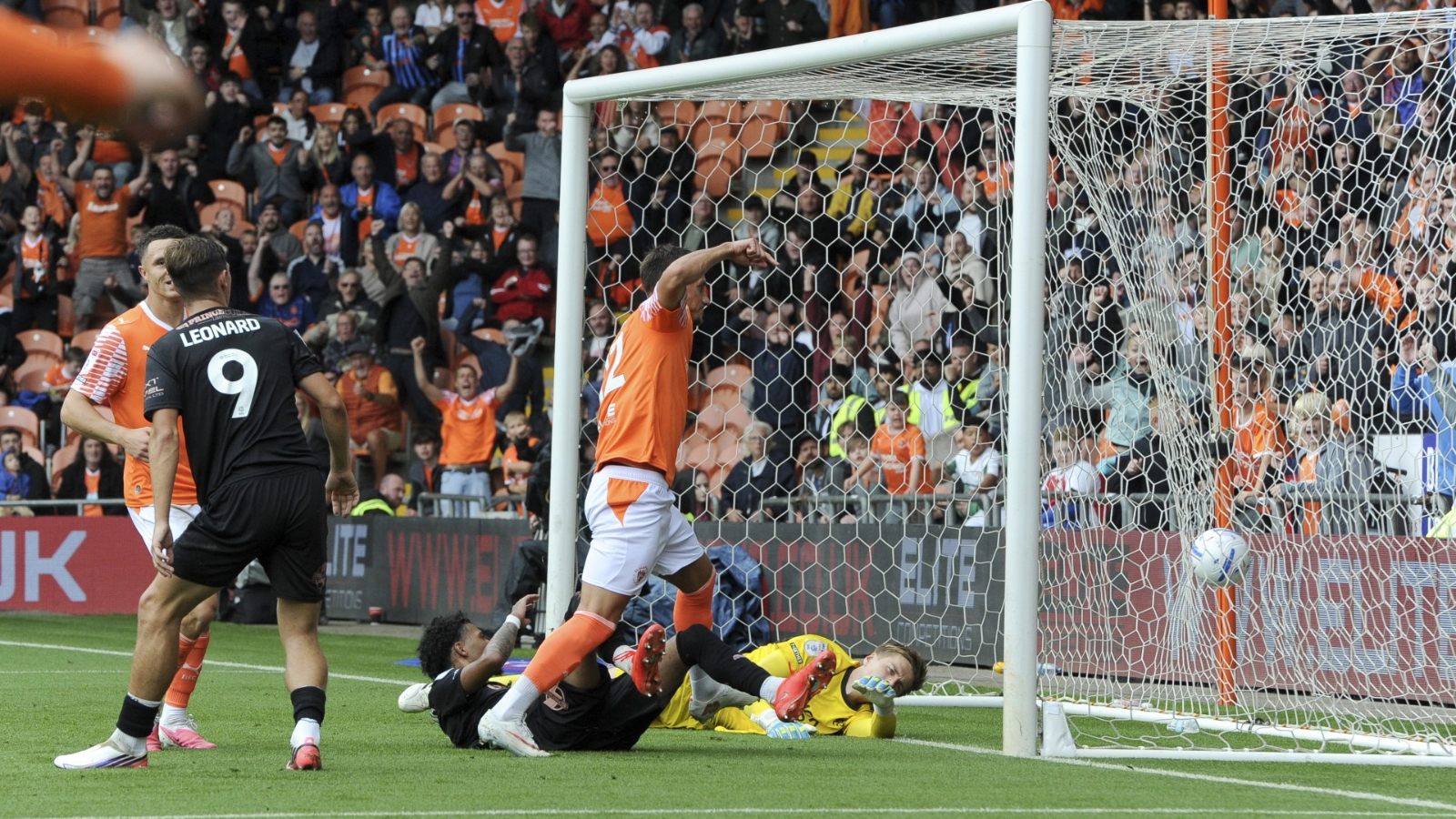 Blackpool’s Jerry Yates pokes past Peterborough United’s Alex Bass to make it 4-0