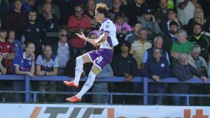 Crawley Town’s Louie Watson celebrates scoring the winning penalty