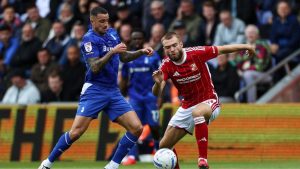 Oldham Athletic’s Oliver Norburn, left, battles with Swindon Town’s Aaron Drinan