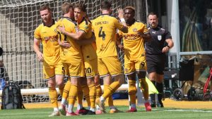 Newport County celebrate their second, scored by Shaquille Gwengwe, right