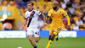 Sheffield United’s Sydie Peck, left, takes on Mansfield Town veteran David McGoldrick in the Carabao Cup.