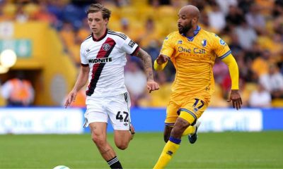 Sheffield United’s Sydie Peck, left, takes on Mansfield Town veteran David McGoldrick in the Carabao Cup.