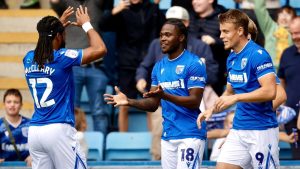 Gillingham’s Sheldon Kendall, centre, takes the congratulations.