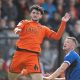Salford City match-winner Joe Powell heads clear.