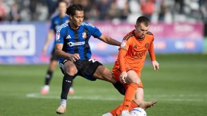 Swindon Town’s Kaelan Majekodunmi, left, challenges Salford City’s Ben Woodburn