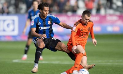 Swindon Town’s Kaelan Majekodunmi, left, challenges Salford City’s Ben Woodburn