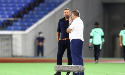 Peter Cklamovski, left, talks with Ange Postecoglou.