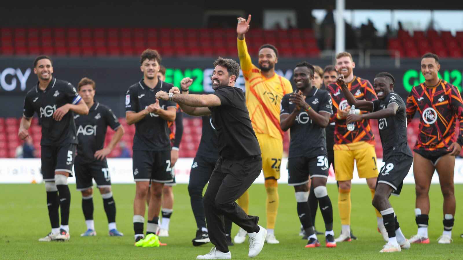 Swansea City and Vitor Matos celebrate their 2-1 victory over Lincoln City that sent them to the top of the Championship.