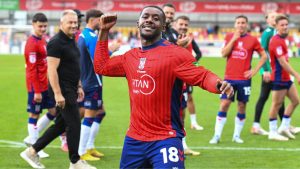 York City’s Jovan Malcolm celebrates with fans at full time