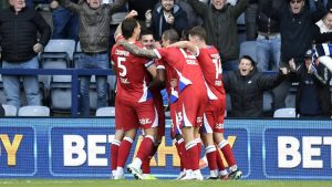 Millwall’s Camiel Neghli, facing, is mobbed by teammates after his winner.
