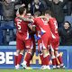 Millwall’s Camiel Neghli, facing, is mobbed by teammates after his winner.