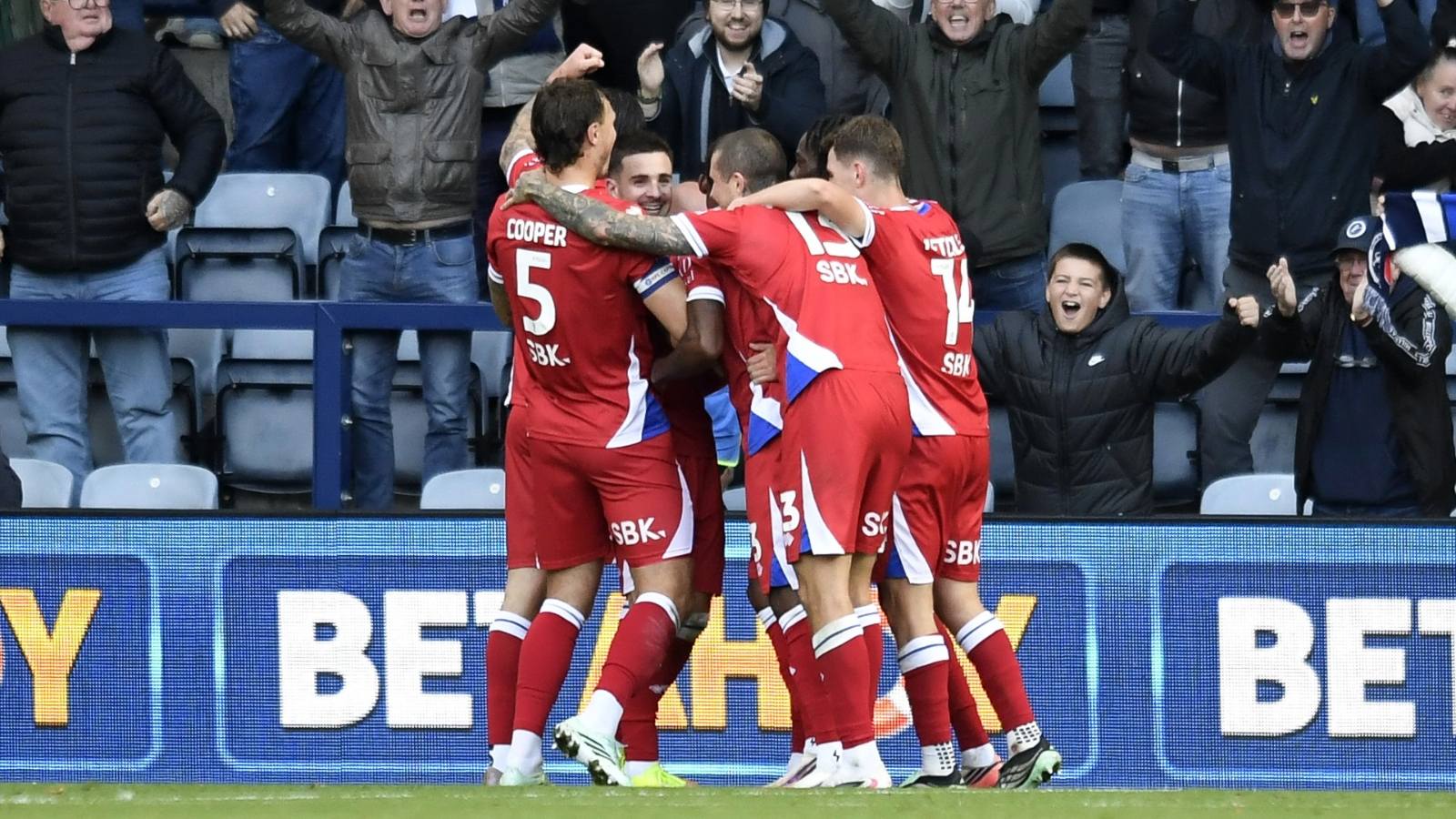 Millwall’s Camiel Neghli, facing, is mobbed by teammates after his winner.