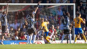 George Lloyd, centre, wheels away after giving Shrewsbury Town the lead.