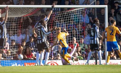 George Lloyd, centre, wheels away after giving Shrewsbury Town the lead.