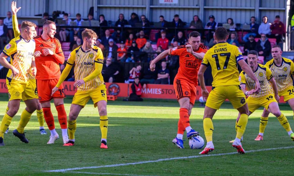 Salford City goalscorer Macaulay Langstaff is outnumbered