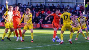 Salford City goalscorer Macaulay Langstaff is outnumbered