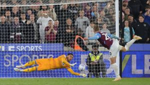 QPR keeper Pierce Charles plunges to his left to keep out Jarrod Bowen’s late spot-kick for West Ham.