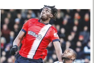 HIGH RISE: Luton’s Elijah Adebayo leaps for the ball PICTURES: George Dunn