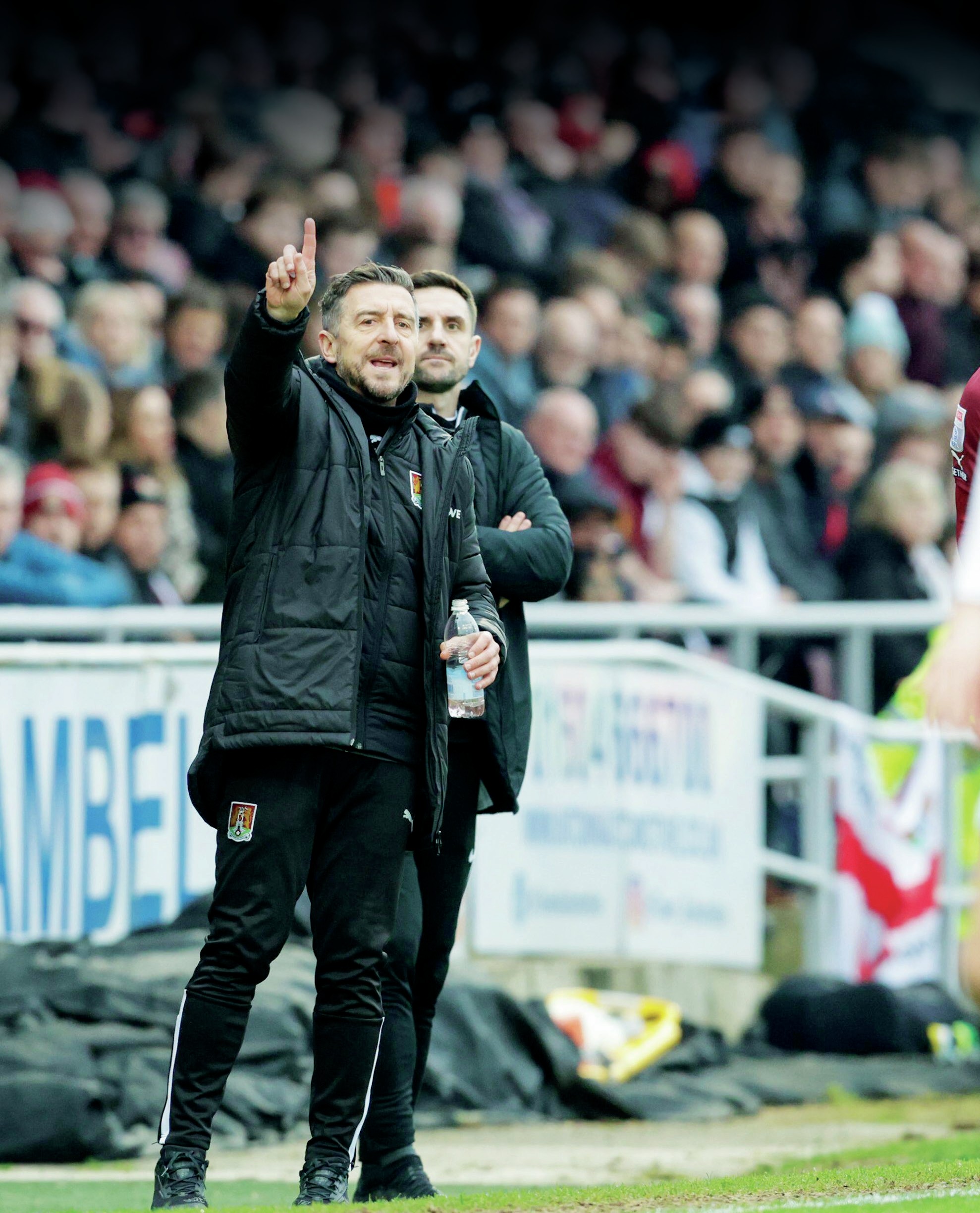 MAKING HIS POINT: Jon Brady on the touchline as Northampton manager and, Insets, celebrating promotion with the Cobblers in 2023, fourth from right, and Spurs boss Ange PostecoglouPICTURE: Alamy