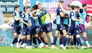 LATE SHOW: Wycombe Wanderers are jubilant after Caleb Taylor’s match-winning goal PICTURES: Alamy