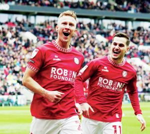 GRIN IT TO WIN IT: Bristol City’s Ross McCrorie, left, celebrates his winner PICTURES: Alamy