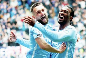 HAVING A LAUGH: Matt Grimes, left, celebrates scoring the Sky Blues’ second with Haji Wright PICTURES: Alamy