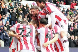 MOB RULE: Ben Wilmot is mobbed after scoring Stoke’s second goal PICTURES: Richard Parkes