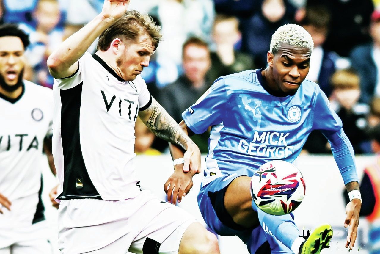 COMMITMENT: Stockport’s Will Collar, left, battles with Posh’s Malik Mothersille PICTURES: MI News & Sport
