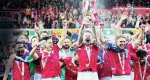 WOW: Wrexham’s James McClean lifts the trophy after sealing promotion PICTURES: Alamy