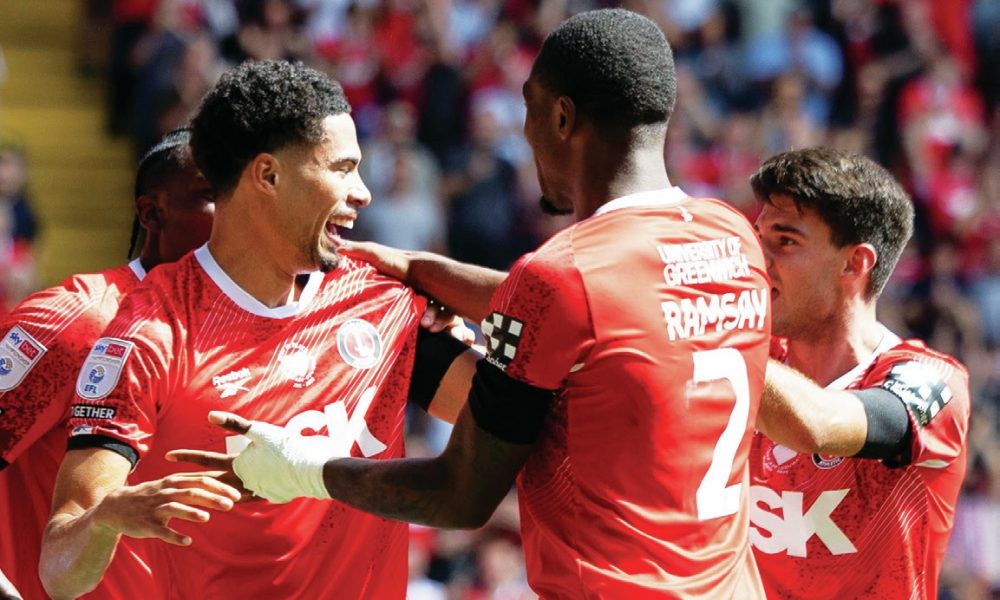 ALL SMILES: Charlton’s Harvey Knibbs, left, celebrates his late winner with his teammates PICTURES: Focus Images